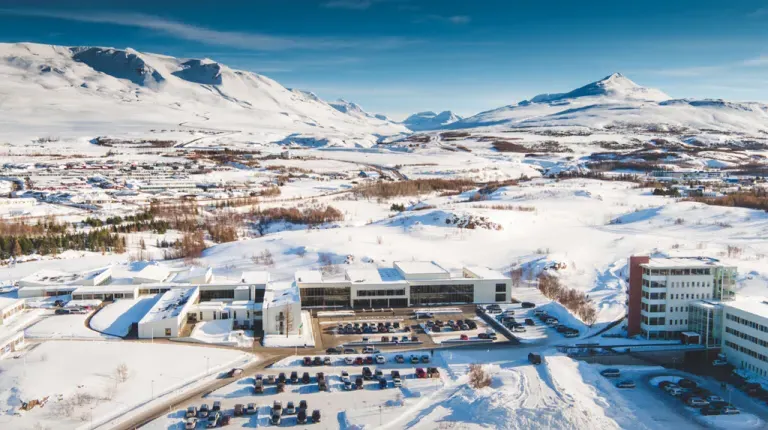 A university campus and surrounding mountains covered in snow